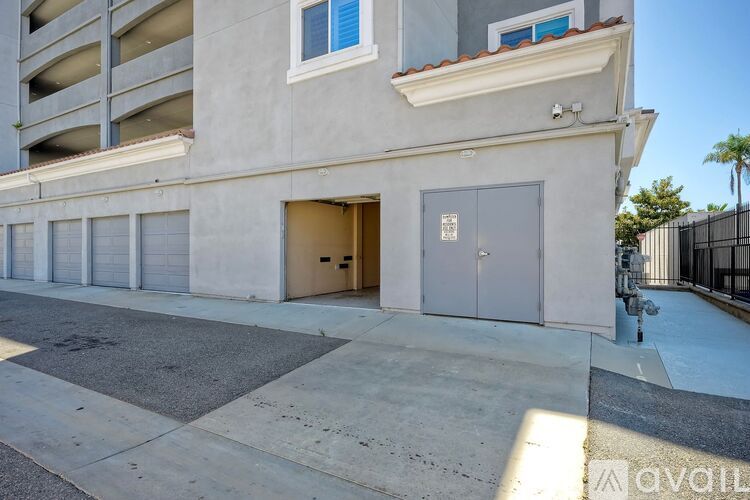 A building with a garage door open and a sign that says "available".