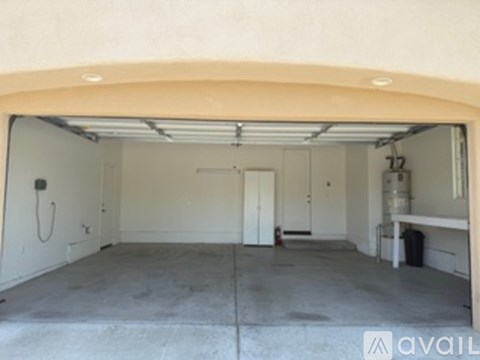 A large empty garage with a door and a window.