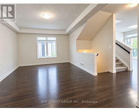 A spacious room with wooden floors and a window.