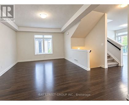 A spacious room with wooden floors and a window.
