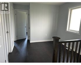 A room with a wooden floor and a window.