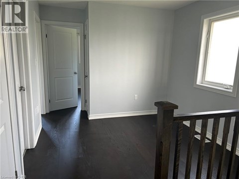 A room with a wooden floor and a window.