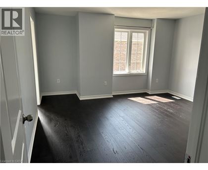 A room with a window and wooden flooring.