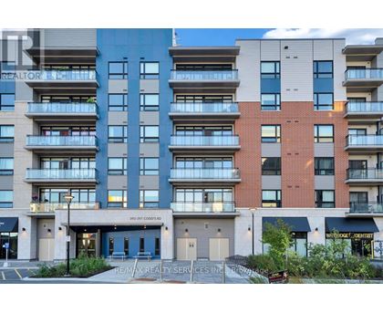 A multi-story apartment building with a Re/Max Realty Services Inc. sign in front.