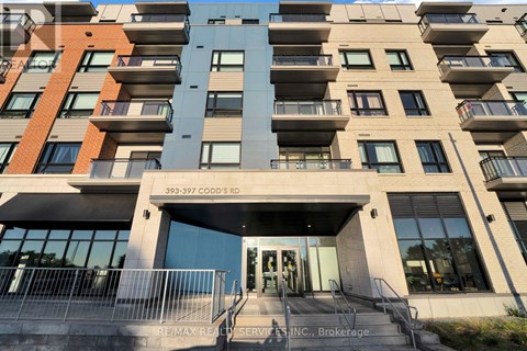 The building is a multi-story residential apartment with a glass entrance door.