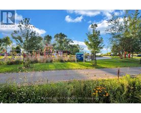 A playground with a blue sign in the foreground and trees in the background.