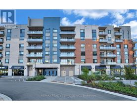 A multi-story apartment building with a parking lot in front.