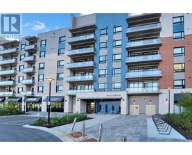 A modern apartment building with a parking lot in front.