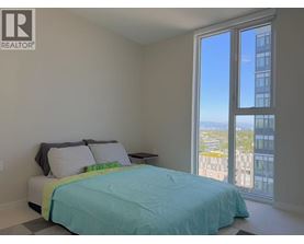 A bedroom with a large bed and a view of the city.