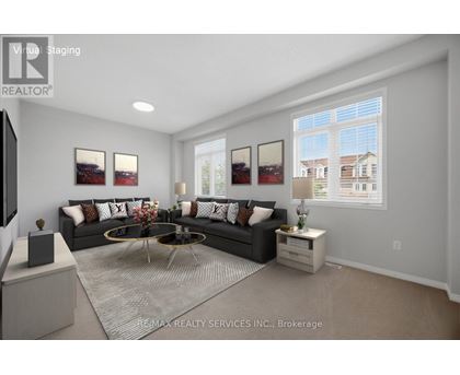 A modern living room with a large sectional sofa and a coffee table in the center.