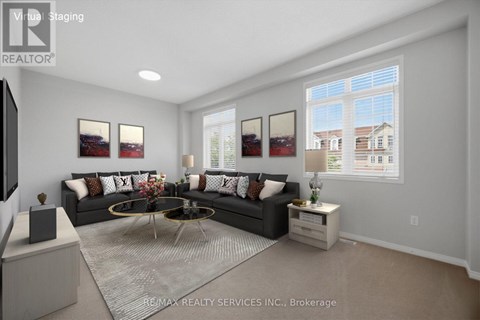 A modern living room with a large sectional sofa and a coffee table in the center.