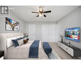 A bedroom with a large bed and a TV on the wall.