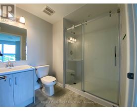 A white bathroom with a walk in shower.
