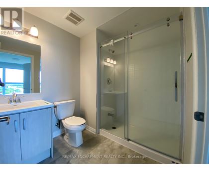 A white bathroom with a walk in shower.