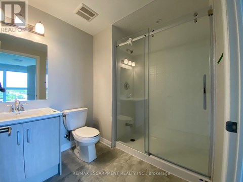 A white bathroom with a walk in shower.