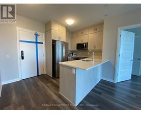A kitchen with a white counter top and wooden cabinets.