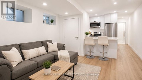 A modern living room with a grey sofa and a wooden coffee table.