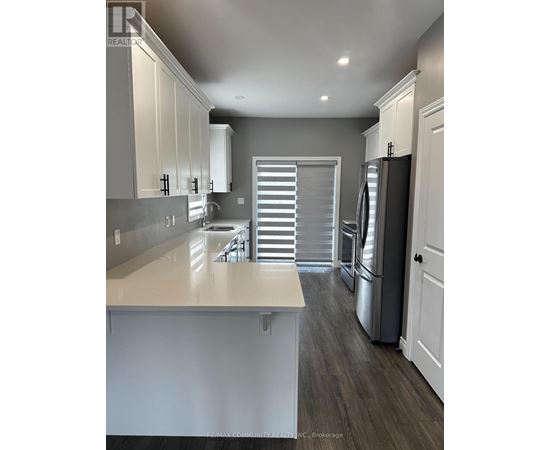 A kitchen with white cabinets and a large island.
