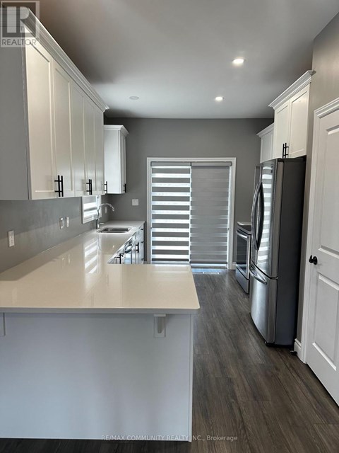 A kitchen with white cabinets and a large island.