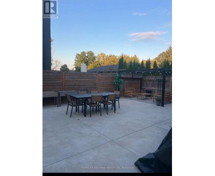 A backyard with a table and chairs.