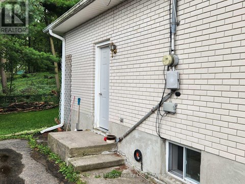 A house with a white door and a small window on the side.
