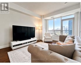 A living room with a flat screen TV and a couch.