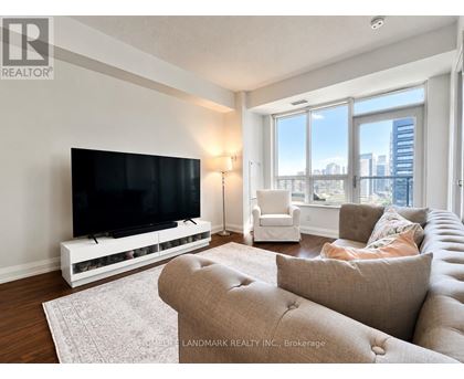 A living room with a flat screen TV and a couch.