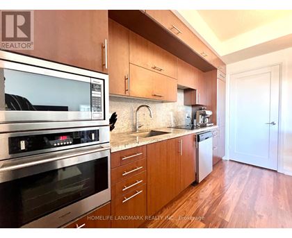 A kitchen with wooden cabinets and a stainless steel oven.