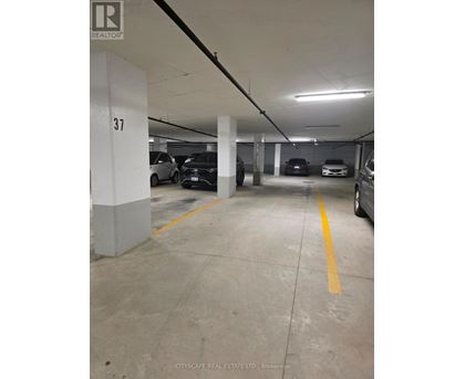 A parking garage with the number 37 on a pillar.