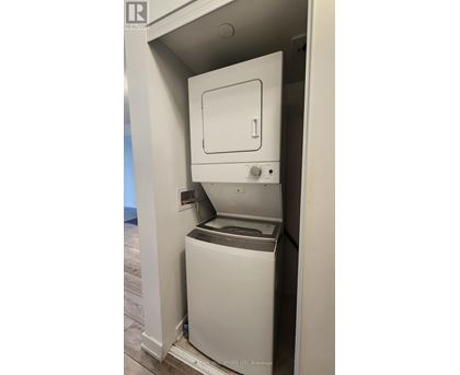 A white dishwasher is built into a kitchen cabinet.