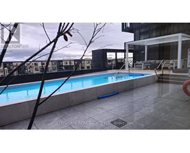 A pool in a residential area with a building in the background.