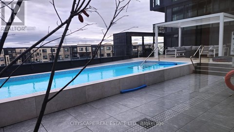 A pool in a residential area with a building in the background.