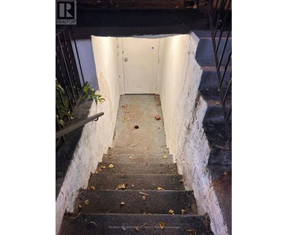 A stairway with a white door at the top.