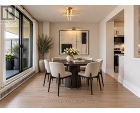 A dining room with a table set for four.