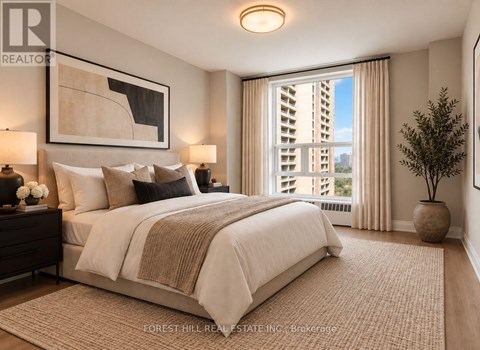 A bedroom with a large bed and a view of a building outside the window.