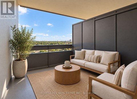 A living room with a couch, chair, and table with a view of the city.