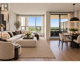 A living room with a large window overlooking a cityscape.