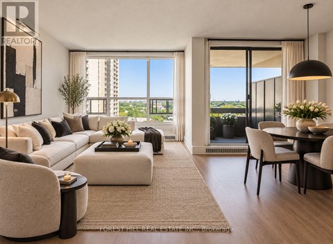 A living room with a large window overlooking a cityscape.