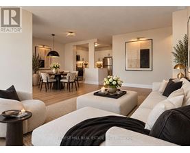 A living room with a dining area in the background.