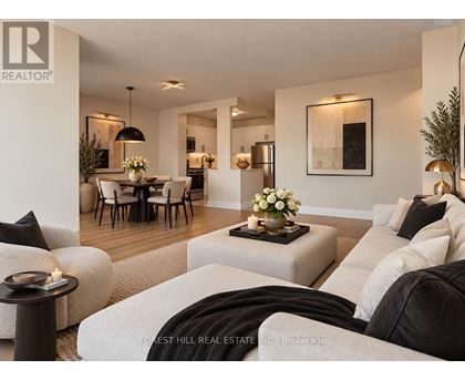 A living room with a dining area in the background.