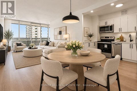 A modern dining room with a round table and chairs.