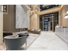 A modern living room with a fireplace and a reception desk.