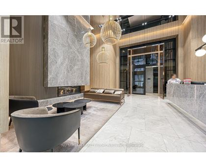 A modern living room with a fireplace and a reception desk.