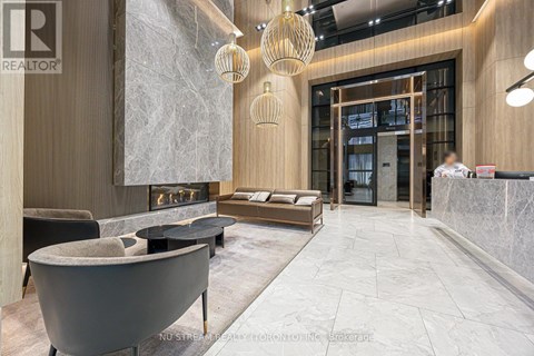 A modern living room with a fireplace and a reception desk.