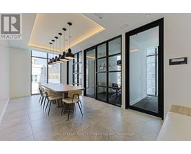 A modern dining room with a table set for four.