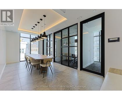 A modern dining room with a table set for four.