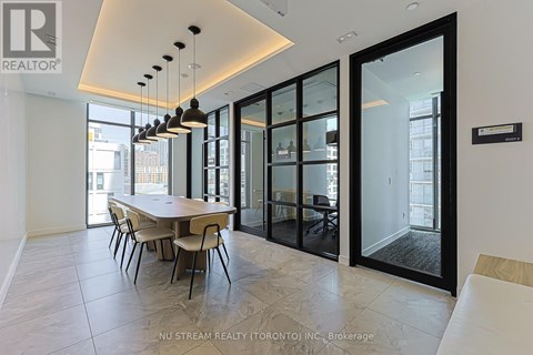 A modern dining room with a table set for four.