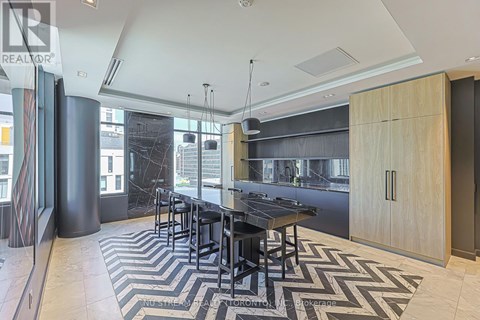 A modern kitchen with a black table and chairs.