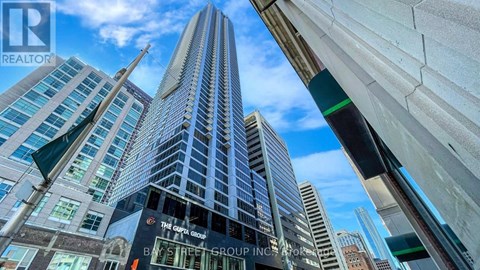A tall building with a glass facade is the focal point of the image.