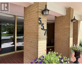 A building entrance with a number 57 on the pillar.